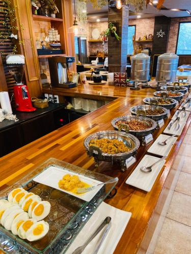 a buffet line with many different types of food at Spring Ground Resort in Renai