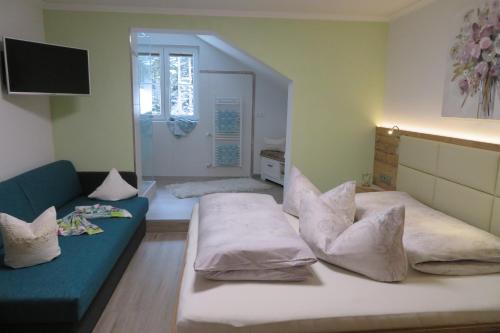 a living room with a bed and a couch at Apartments Egger Barbara in Gosau
