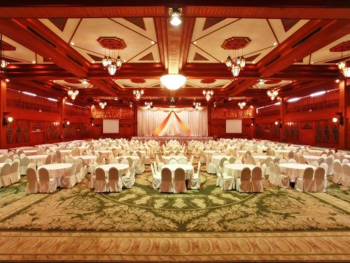 a large banquet hall with white tables and chairs at Chiang Mai Phucome Hotel in Chiang Mai