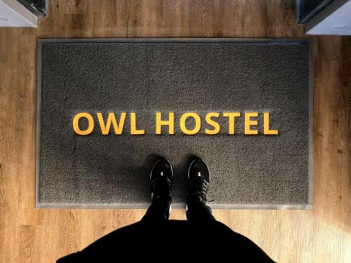 a person standing in front of a sign that reads owl hospital at Owl Hostel 貓頭鷹旅店 in Yuchi
