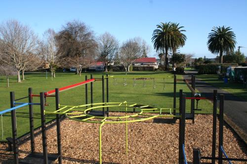 a playground in a park with a play equipment at Levin TOP 10 Holiday Park in Levin