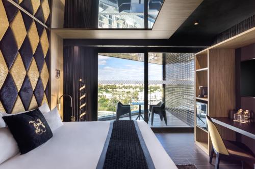 a bedroom with a bed and a large window at H Hotel & SPA - Adults Only in St Julian's