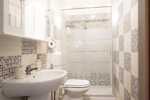 Un baño blanco con inodoro y lavabo. en Affittacamere Romina, en Bolonia