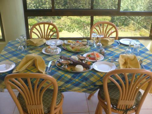 a table with a plate of food on it at LUSHOTO EXECUTIVE LODGE in Lushoto