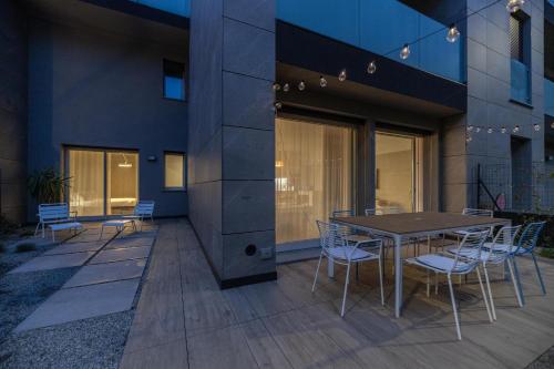 a patio with a table and chairs in front of a building at Il Garovaglio in Como