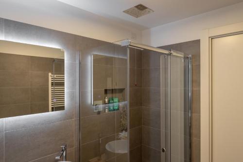 a bathroom with a shower with a sink and a mirror at Il Garovaglio in Como