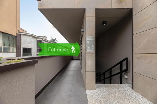 a hallway of a building with a green entrance sign at Il Garovaglio in Como