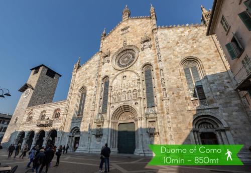 a large stone church with people walking in front of it at Il Garovaglio in Como