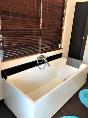 a white bath tub in a bathroom with a window at Dům nad Pržnem in Jablŭnka