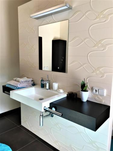 a bathroom with a sink and a mirror at Dům nad Pržnem in Jablŭnka
