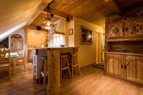 a kitchen with a bar and a dining room at Hotel Bambi Boutique in Zakopane