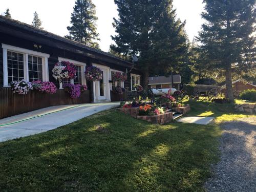 a house with flowers on the side of it at Antlers Lodge in Cooke City