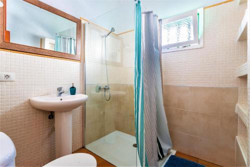 a bathroom with a shower and a sink at Casajardin in Playa Honda