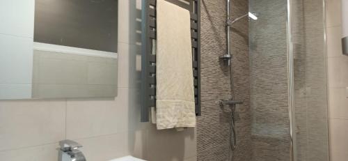 a bathroom with a shower with a glass door at Apartamento Mar deluxe Suances in Suances