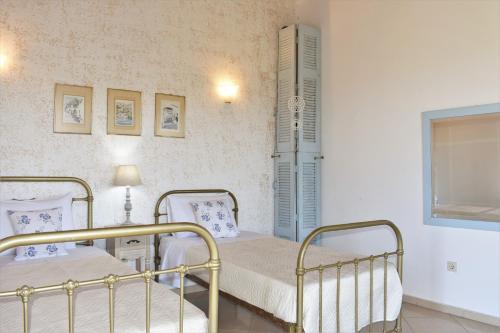 a hospital room with two beds and a window at Archontiko tis Irinis in Ádhele