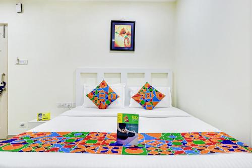 a bedroom with a bed with a colorful rug at FabHotel Colors Service Apartment in Chennai
