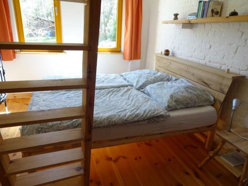 a bedroom with a bunk bed and a ladder at Ferienhaus Lehmannsbrück in Wolfsberg