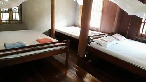 a room with two bunk beds in a room at Tran Xuan Homestay Ba Be Village in Ba Be