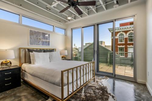 a bedroom with a bed and a large window at Luxury Arts District Apartments in New Orleans