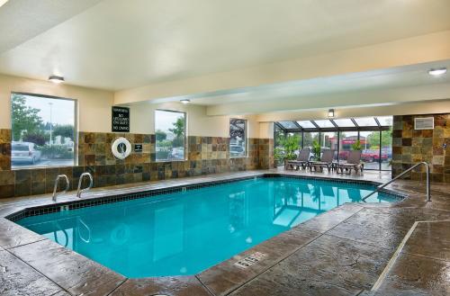 a large swimming pool with blue water at Oxford Suites Spokane Valley in Spokane Valley