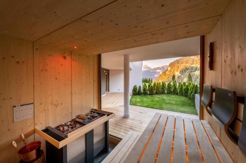a house with a view of a kitchen with a stove at Hotel Platz in Ortisei
