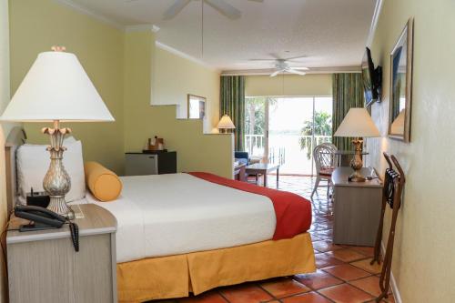 a bedroom with a bed and a living room at Jupiter Waterfront Inn in Jupiter