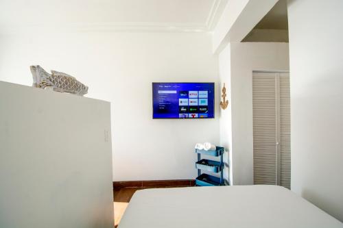 a bedroom with a bed and a tv on the wall at BEACHFRONT Escape - Cozy Studio in Tijuana