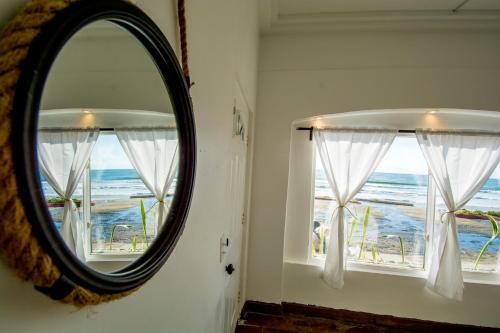 a mirror in a room with a view of the ocean at BEACHFRONT Escape - Cozy Studio in Tijuana