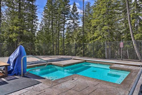 a swimming pool in a backyard with a fence at Airy Resort Condo Less Than 3 Miles to Whitefish Mountain! in Whitefish