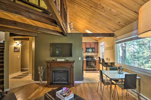 a living room with a fireplace and a television at Airy Resort Condo Less Than 3 Miles to Whitefish Mountain! in Whitefish