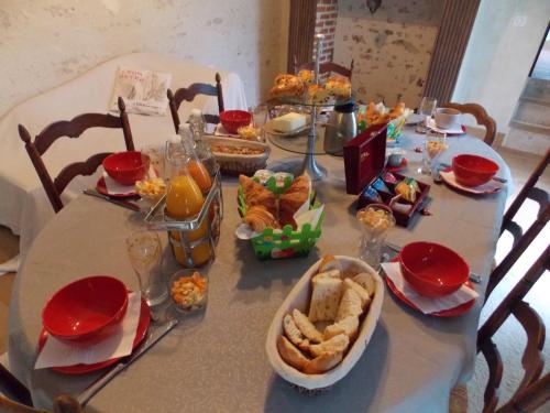 a table with a table cloth with food on it at Domaine du Gué du Roi in Cléry-Saint-André