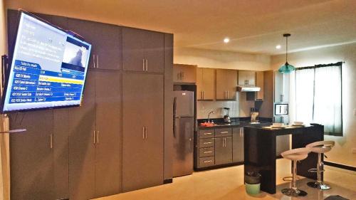 a kitchen with a large screen on the wall at Privatto Suites in Saltillo