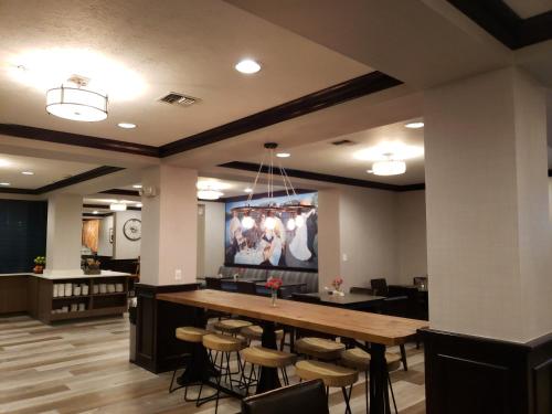 a large dining room with a large table and stools at Oxford Suites Spokane Downtown in Spokane
