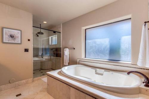 a large bathroom with a tub and a shower at Estate Resort Style Oasis 6BDRM, 5.5 Bath Heated Pool with Misters in Scottsdale