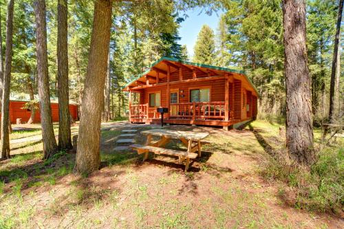 a cabin in the woods with a picnic table in front of it at North Forty Resort in Columbia Falls