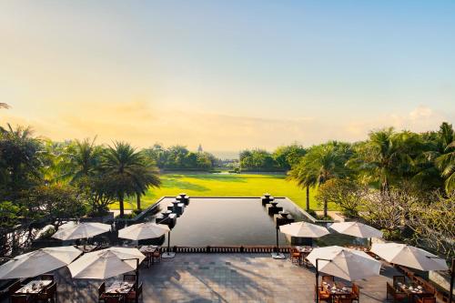 an aerial view of a resort pool with umbrellas at Raffles Hainan Clear Water Bay in Sanya
