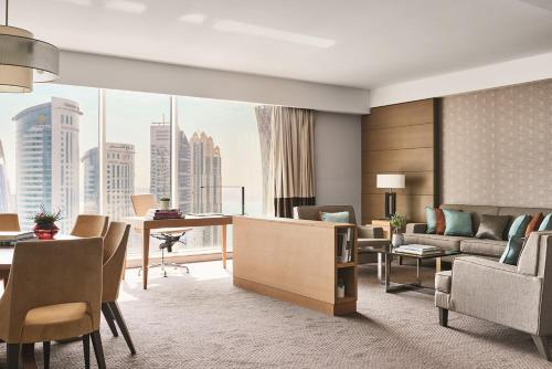 a living room with a view of a building at Pullman Doha West Bay in Doha
