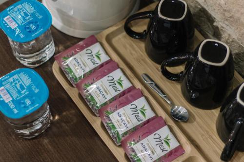 three packets of tofu and bottles of water on a wooden table at Melrose House Hotel in Pamukkale
