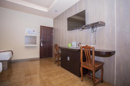 a room with a desk and a chair in a room at Thansila Resort&Garden Buriram in Buriram