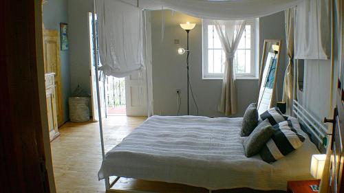 a bedroom with a bed in a room with a window at Maison Roxanne & Maisonette in medieval city by Rhodes4vacation in Rhodes Town