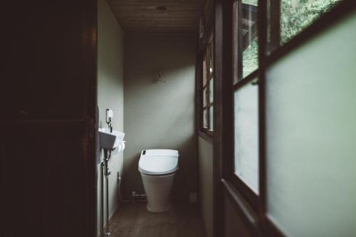 a bathroom with a toilet and a sink at NIPPONIA Kosuge Village in Kosuge