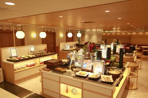 a buffet line in a restaurant with food on display at Hotel Hokke Club Hiroshima in Hiroshima