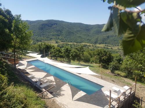uma piscina no meio de uma montanha em novanta nature retreat em Bibbiena