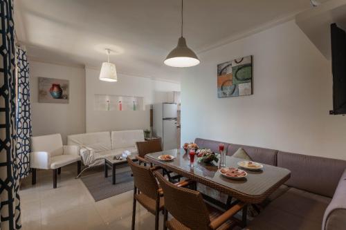 a dining room and living room with a table and chairs at Mirage Hotel Sidi Abd El Rahman in El Alamein