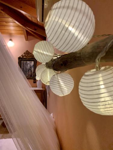 a group of white lights and a curtain at Wooden Roof Apartment in Lixouri