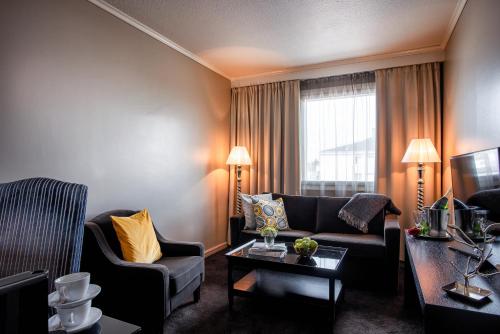 a living room with two couches and a window at Arctic City Hotel in Rovaniemi
