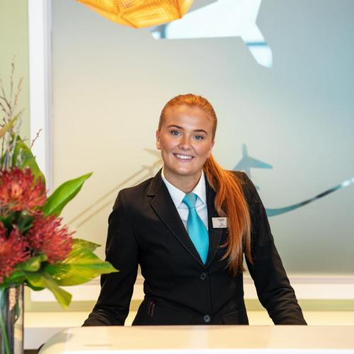 a woman in a suit and a blue tie at Thon Hotel Oslo Airport in Gardermoen