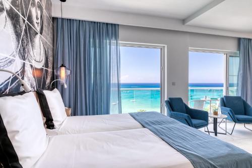 um quarto com uma cama e vista para o oceano em King Jason Protaras - Designed for Adults em Protaras