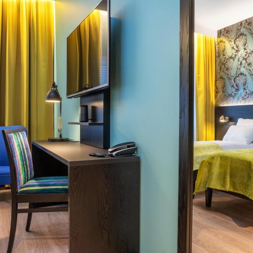 a hotel room with a desk and a bed at Thon Hotel Oslo Airport in Gardermoen