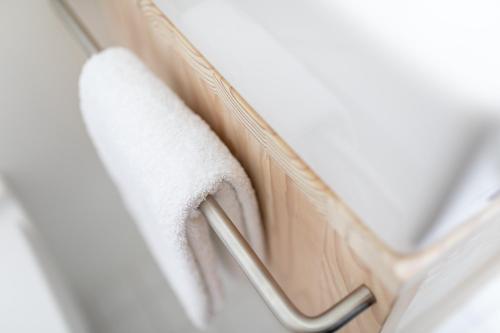 a towel on a towel rack in a hotel room at Vier Häuser in Norderney